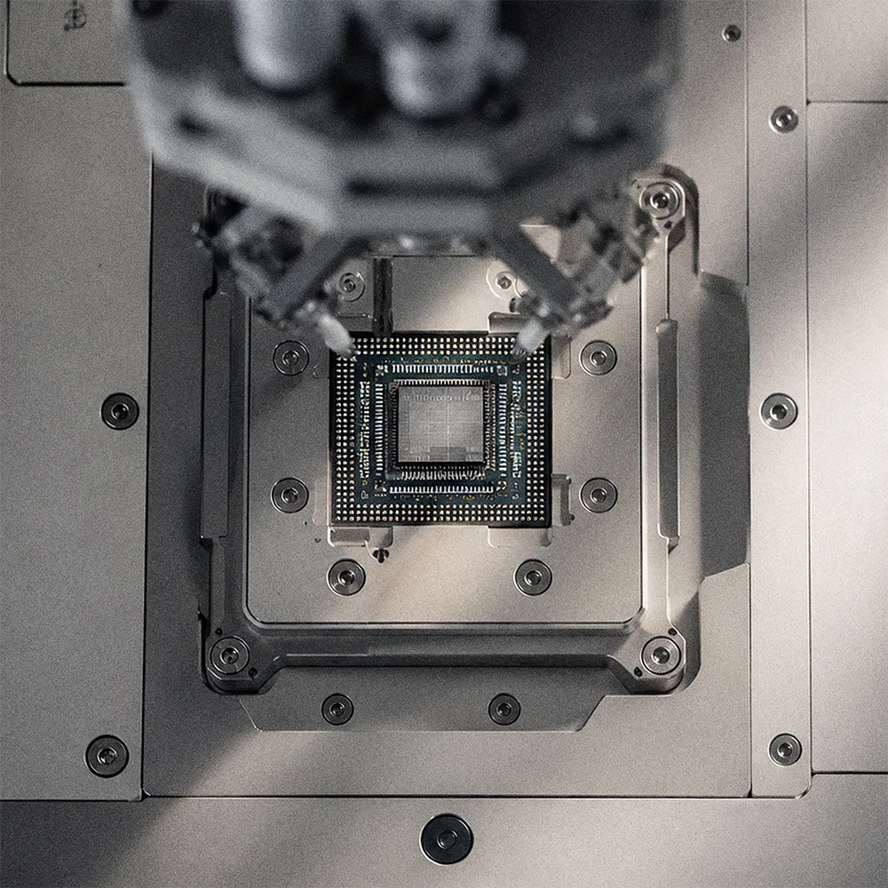 Roboterarm greift einen Computerchip auf einer technischen Oberfläche.